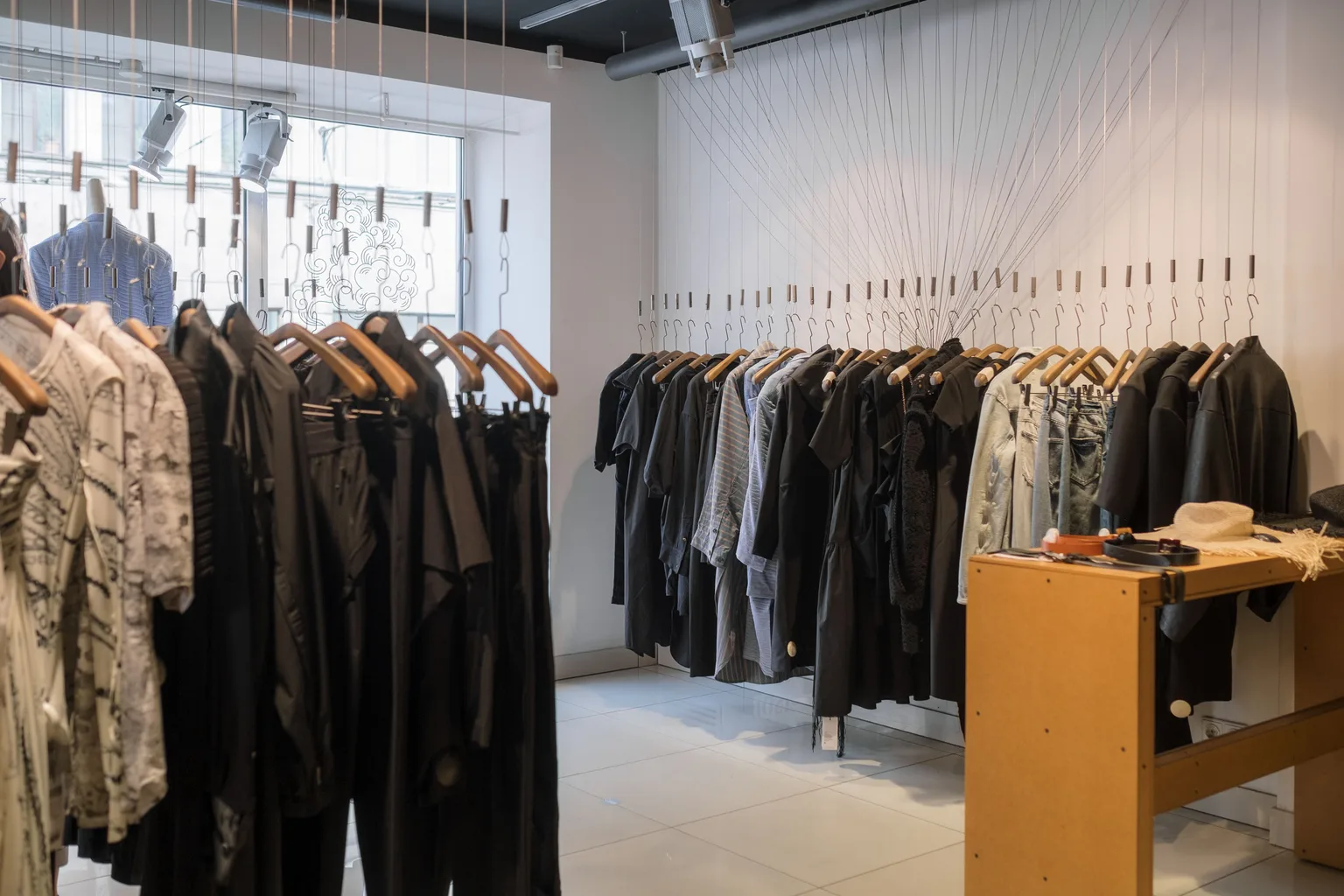 Racks of clothing arranged along the aisles of a bright modern retail store